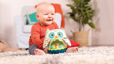 Toddler playing with Owl Sensory toy