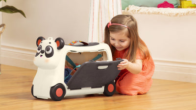 Little Girl playing with Panda B.toy Ride-on toy with storage compartment