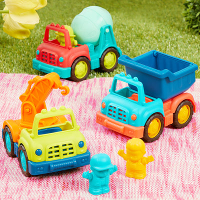 Three toy trucks with drivers.